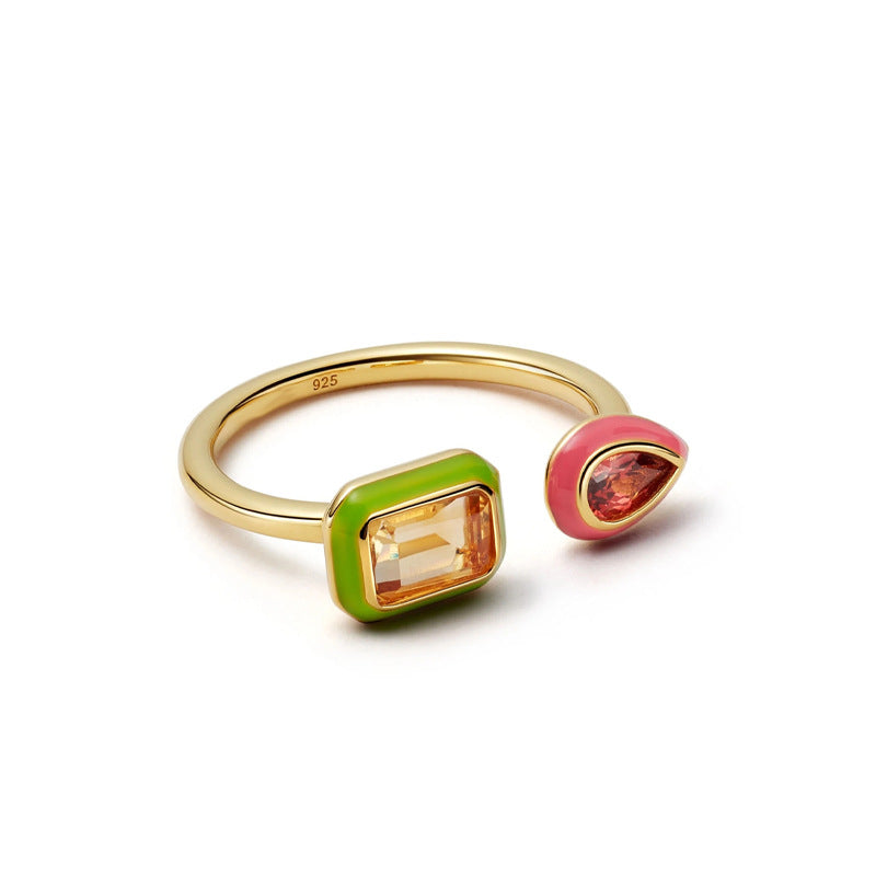 Gold ring with colorful gemstones on a white background
