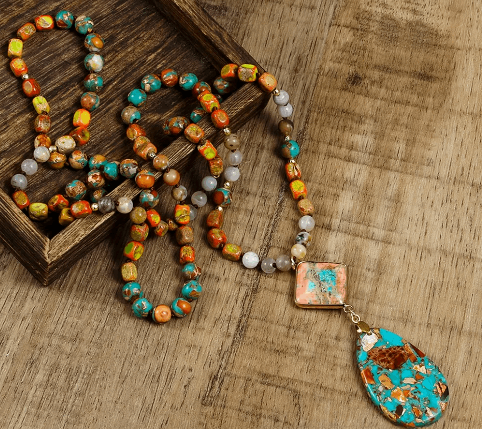 Colorful beaded necklace with a pendant on a wooden surface