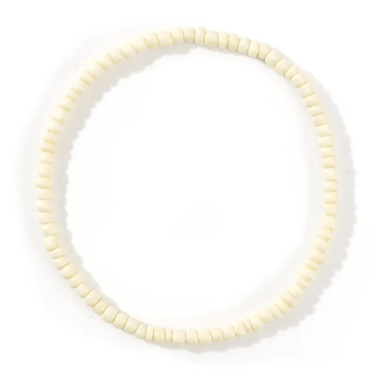 White beaded necklace on a white background