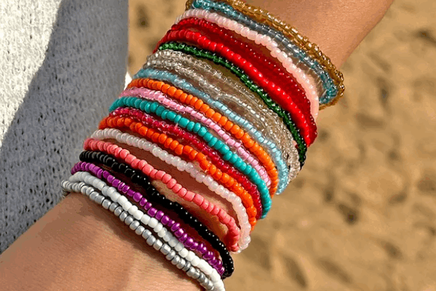 Colorful beaded bracelets on a wrist with a blurred background