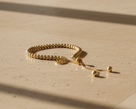 Gold beaded necklace on a white background
