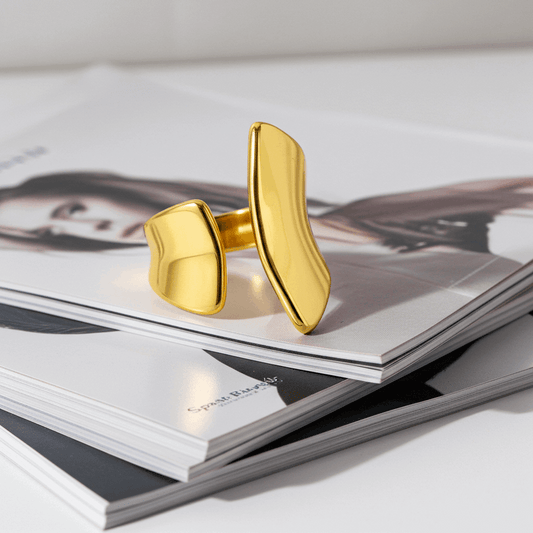 Gold cuff bracelet on a magazine