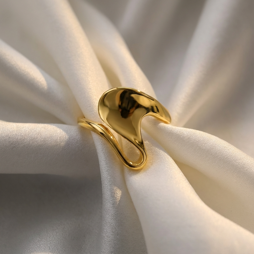 Gold ring on a white fabric background