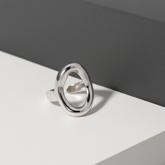Silver ring on a gray and white background